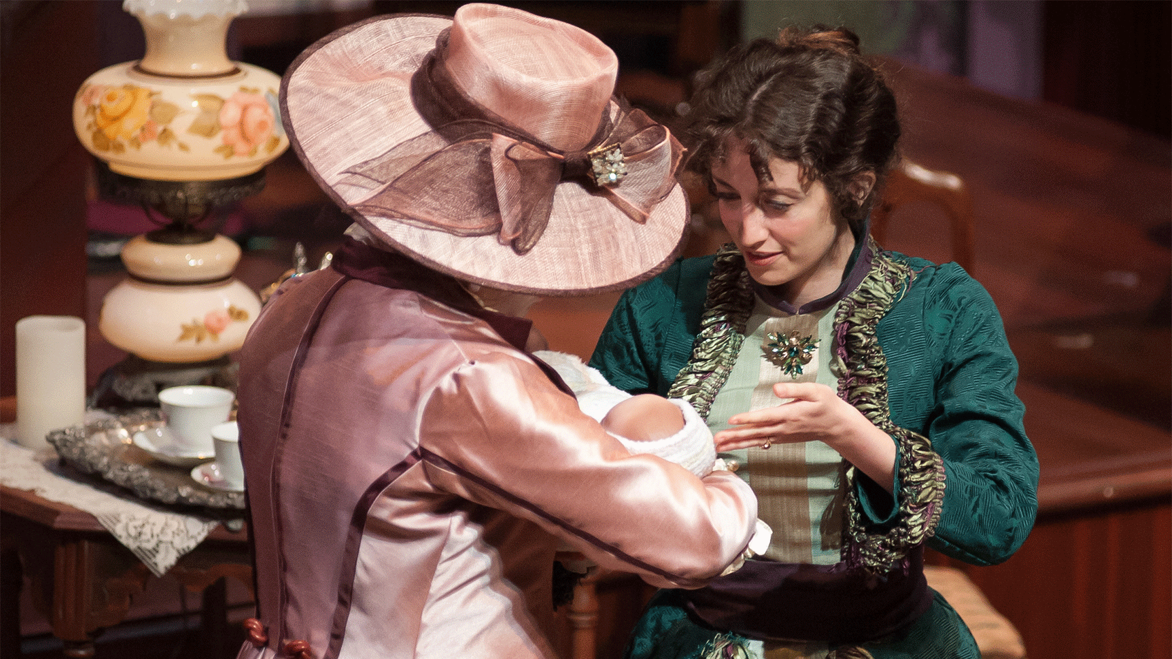 Two women looking at a baby