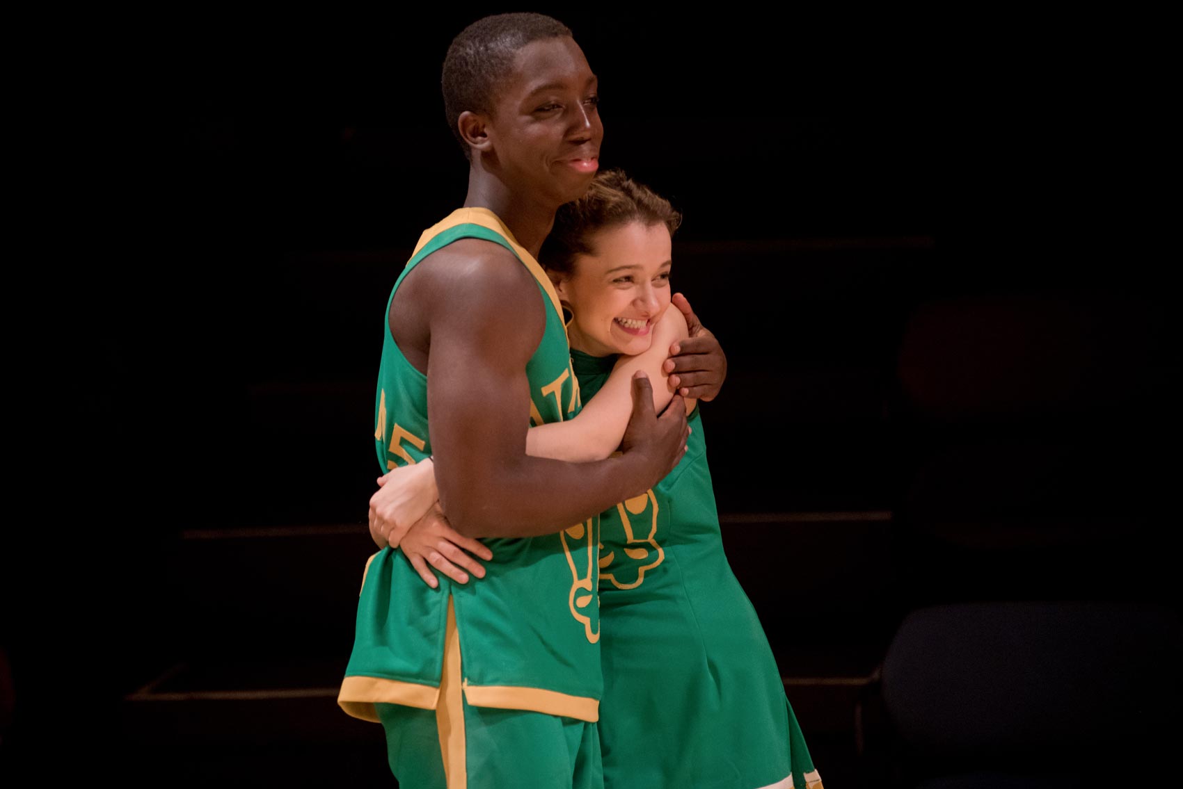 Two basketball players hug one another.