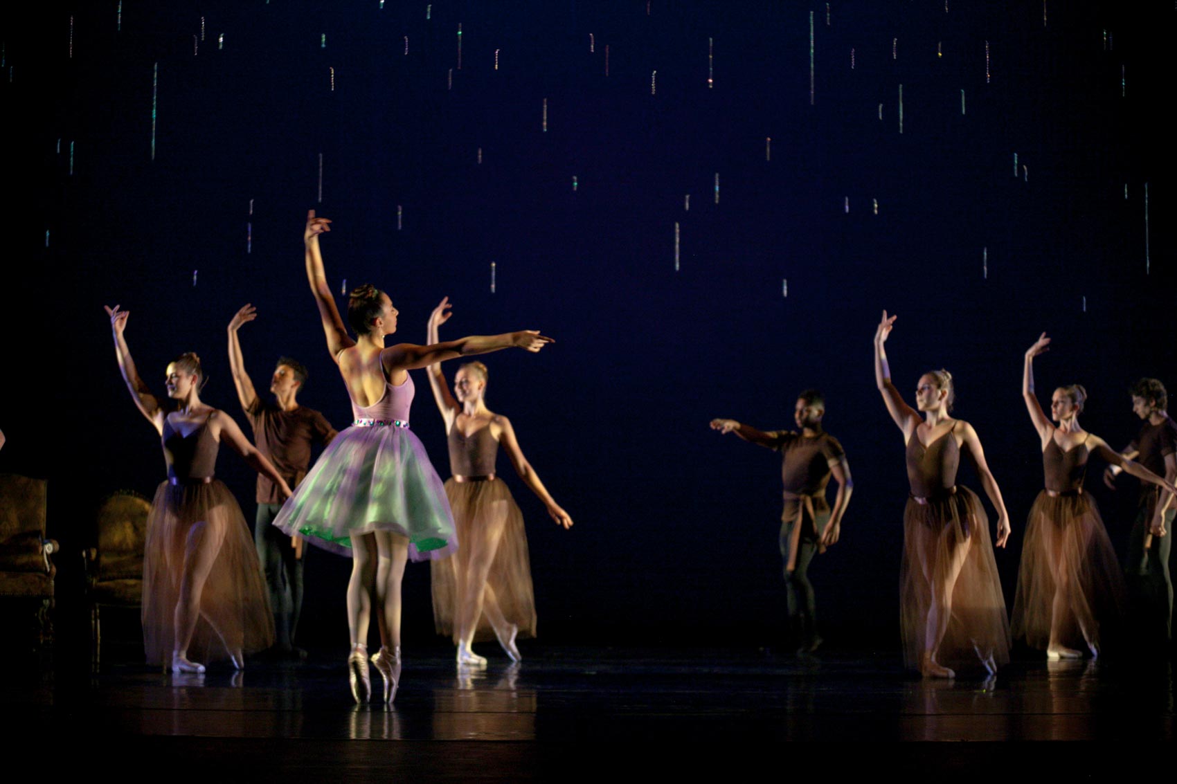 A ballerina stands in the third ballet position.