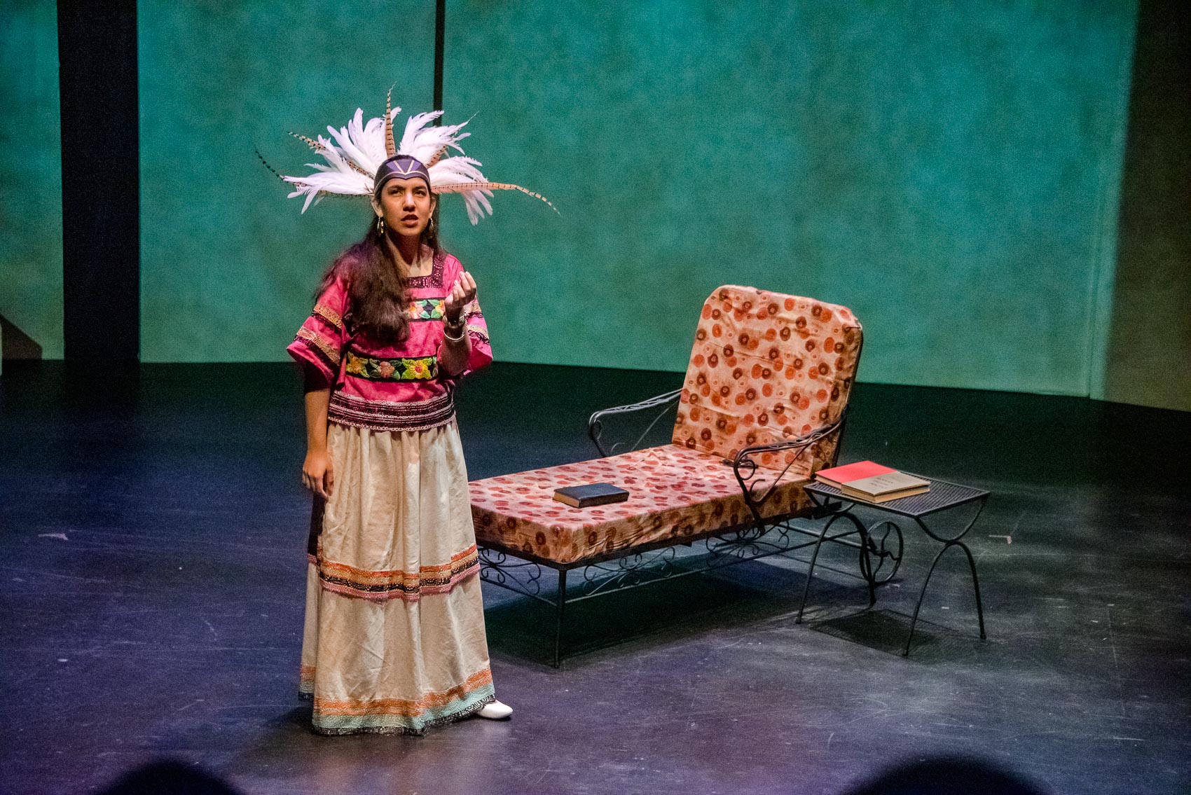 A young woman puts on a native head dress.