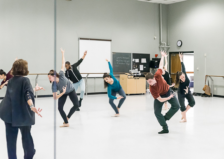 Students practicing dance in the studio.