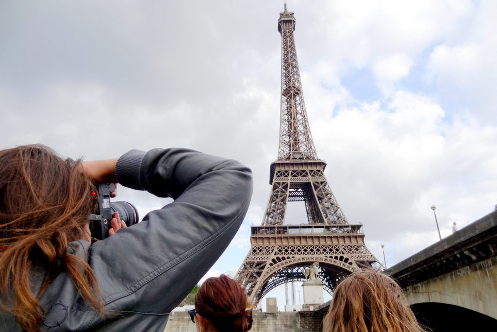 A USF student snaps a photo of the Eiffel Tower in Paris.