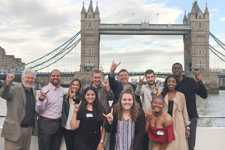 USF students giving the "horns up" salute in front of the Tower Bridge in London.