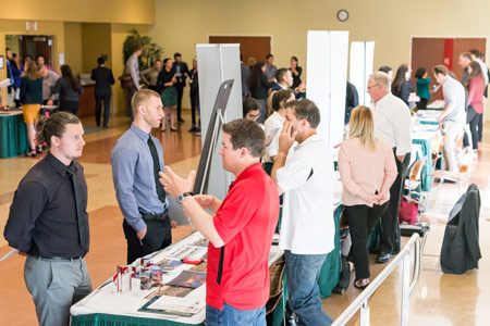 Students meeting recruiters at a job fair.