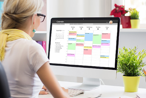 Person managing calendar on computer