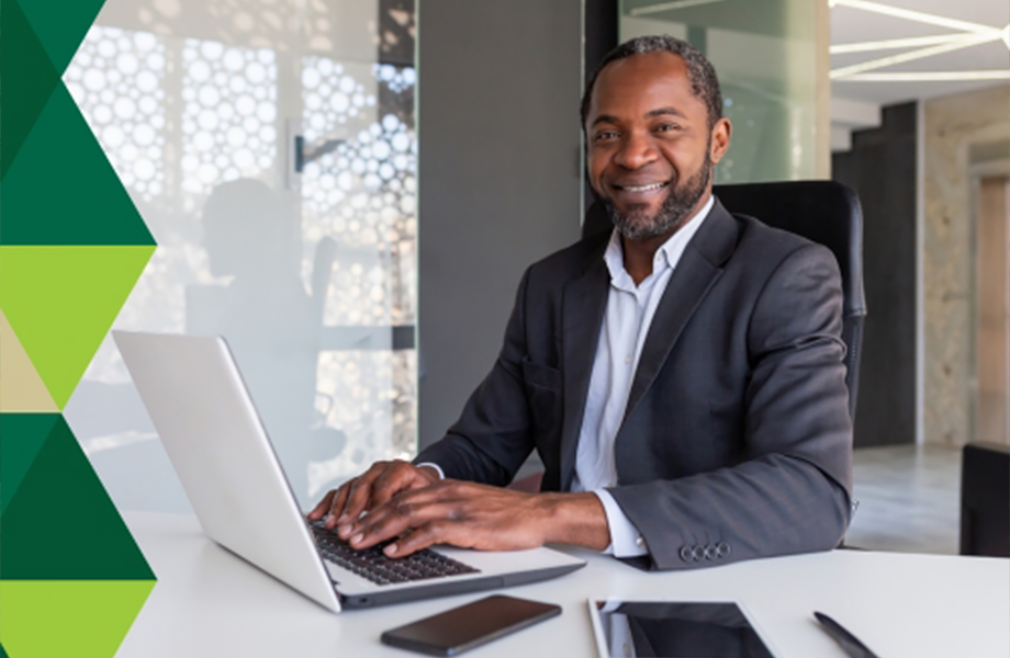 smiling person working on a laptop