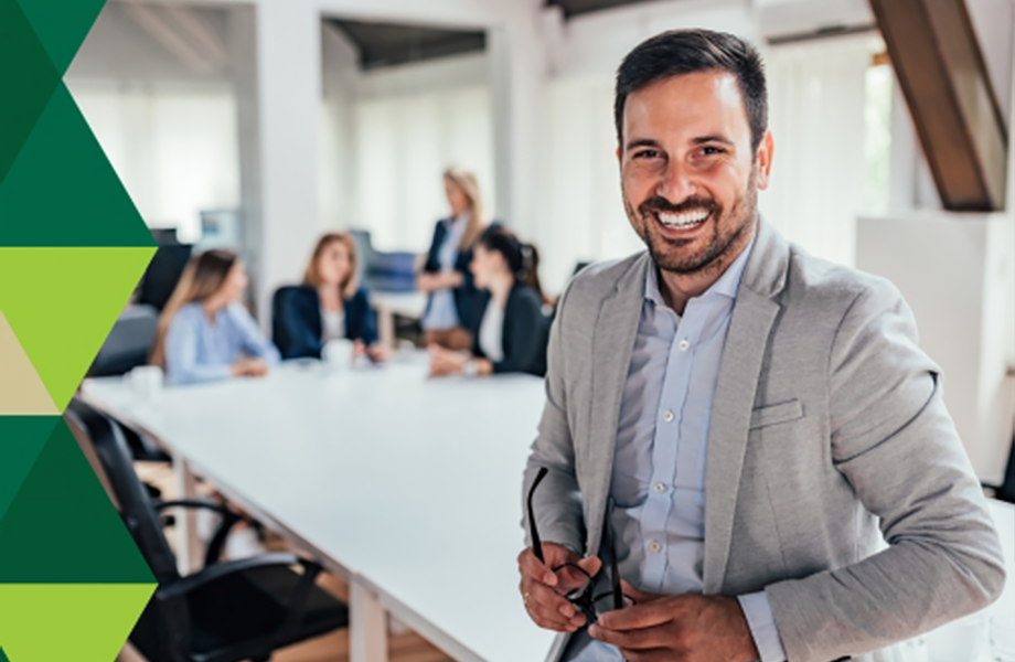 smiling person at the end of a conference table