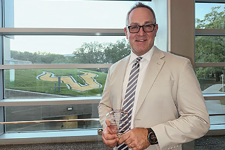 Jay Civitillo holding his award