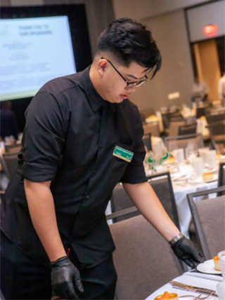 Student setting up table for event