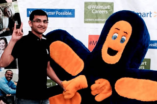 Sushil Akhare posing with Walmart mascot
