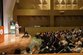 Charlie Strong in front of audience