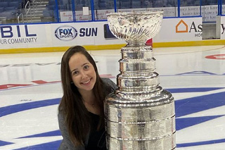 Amy Rubin posting with Stanley Cup