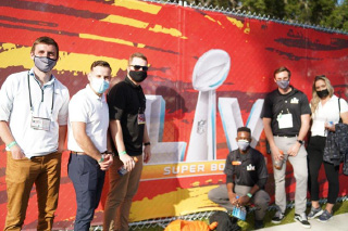 Interns in front of sign