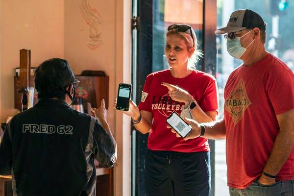 Hospitality workers are required to enforce vaccine and mask mandates, which has led to altercations. AP Photo/Damian Dovarganes