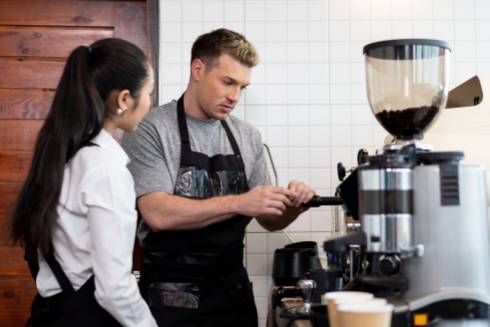 Image of man and woman near a coffee machine. Photo credit Modern Restaurant Management