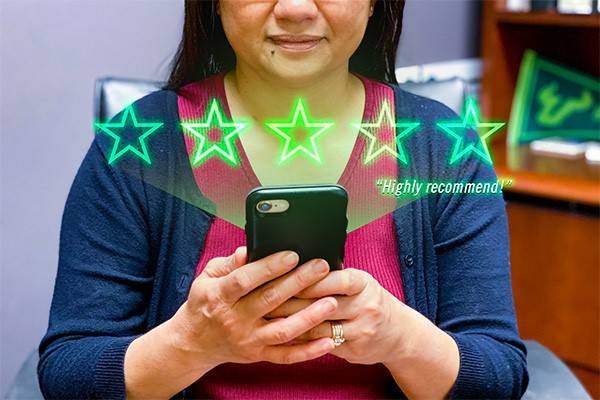 Woman rating something on her iPhone, stars appear as an overlay