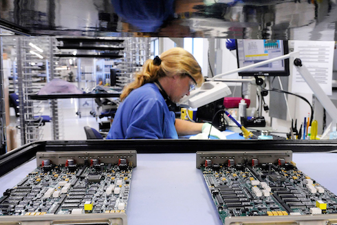 An image of a Jabil employee working on a production line