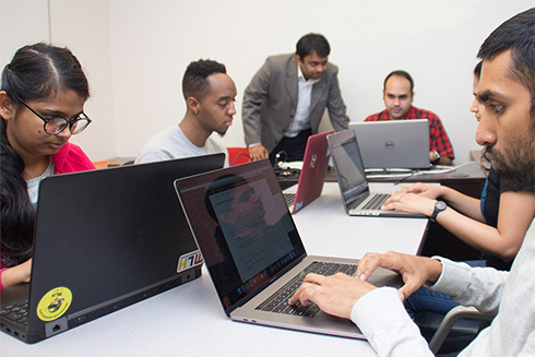image of students on laptops
