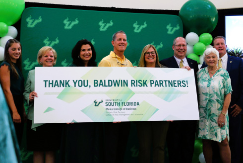 Baldwin Risk Partners, and USF staff and students holding thank you sign