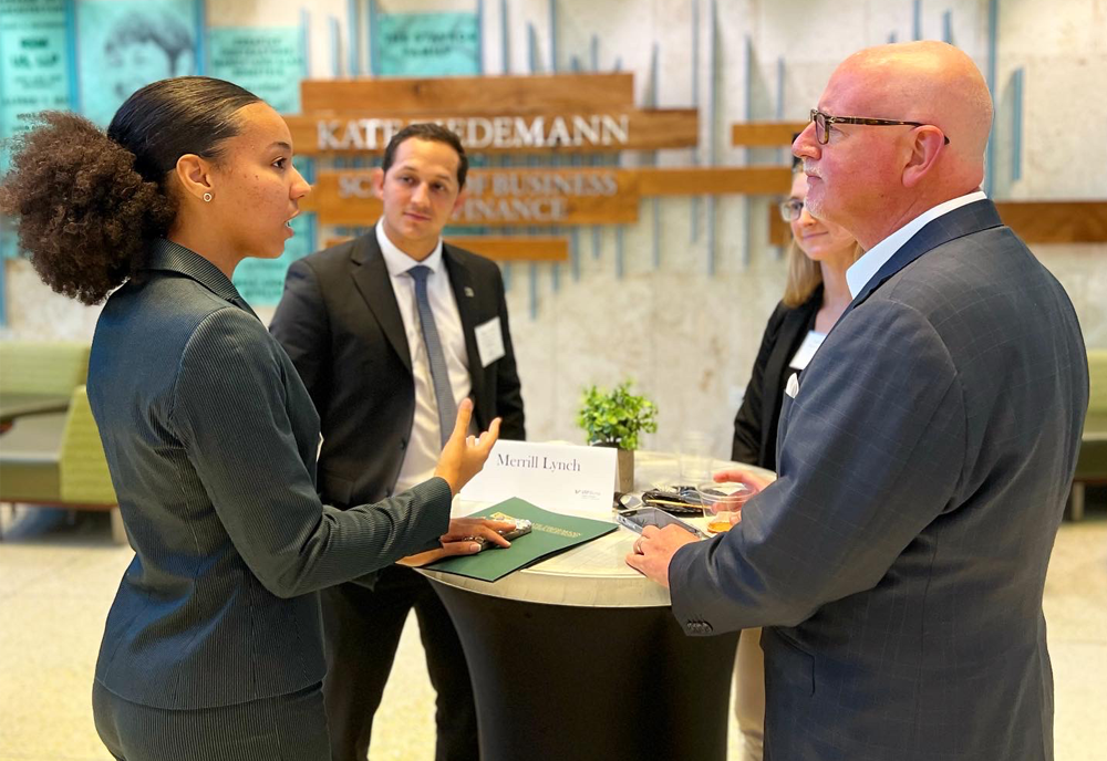 student makes connection while meeting with business professionals 