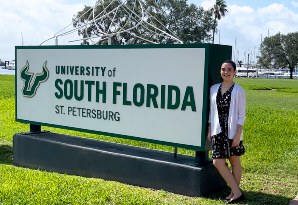 Allison Wightman poses with USF St. Petersburg sign