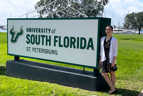 Allison Wightman poses with USF St. Petersburg sign