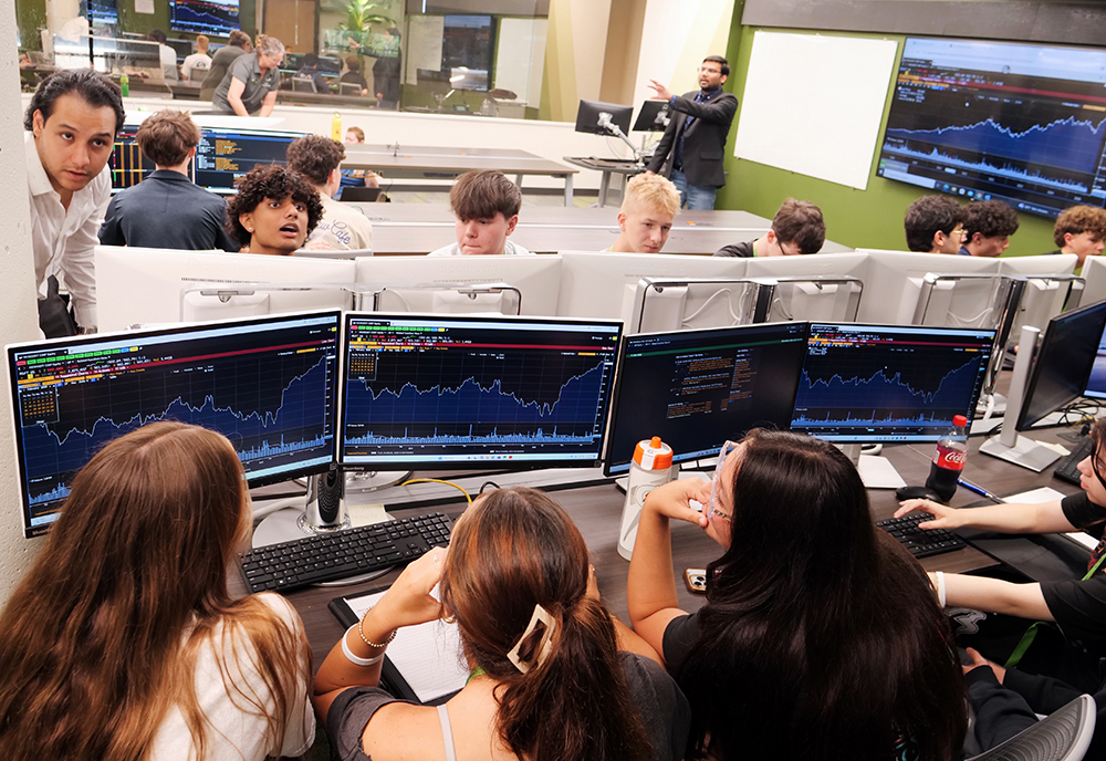 students analyze stocks on the Bloomberg Terminals