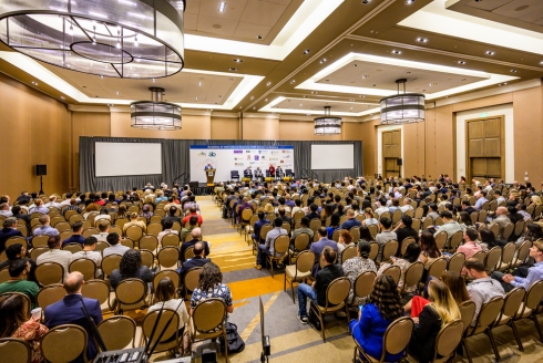 A wide shot showing the crowd and stage at the 2025 AIB conference.