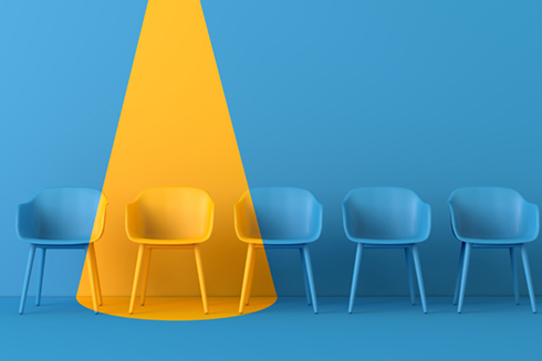 yellow light shining down on blue chairs