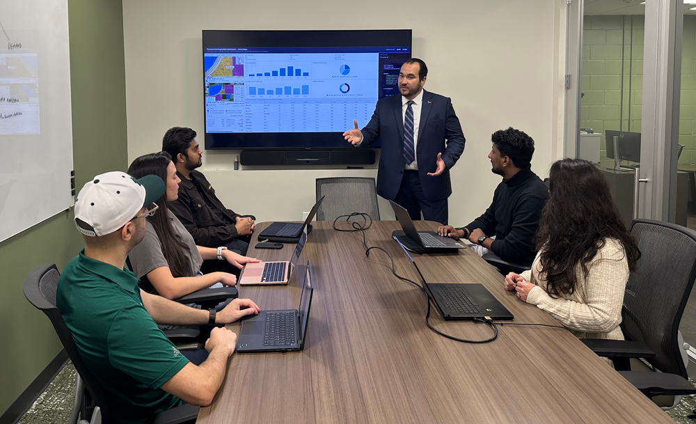 Assistant professor Seçkin Özkul leads a working session with graduate research assistants
