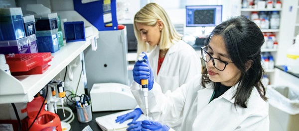 Two students working in a lab