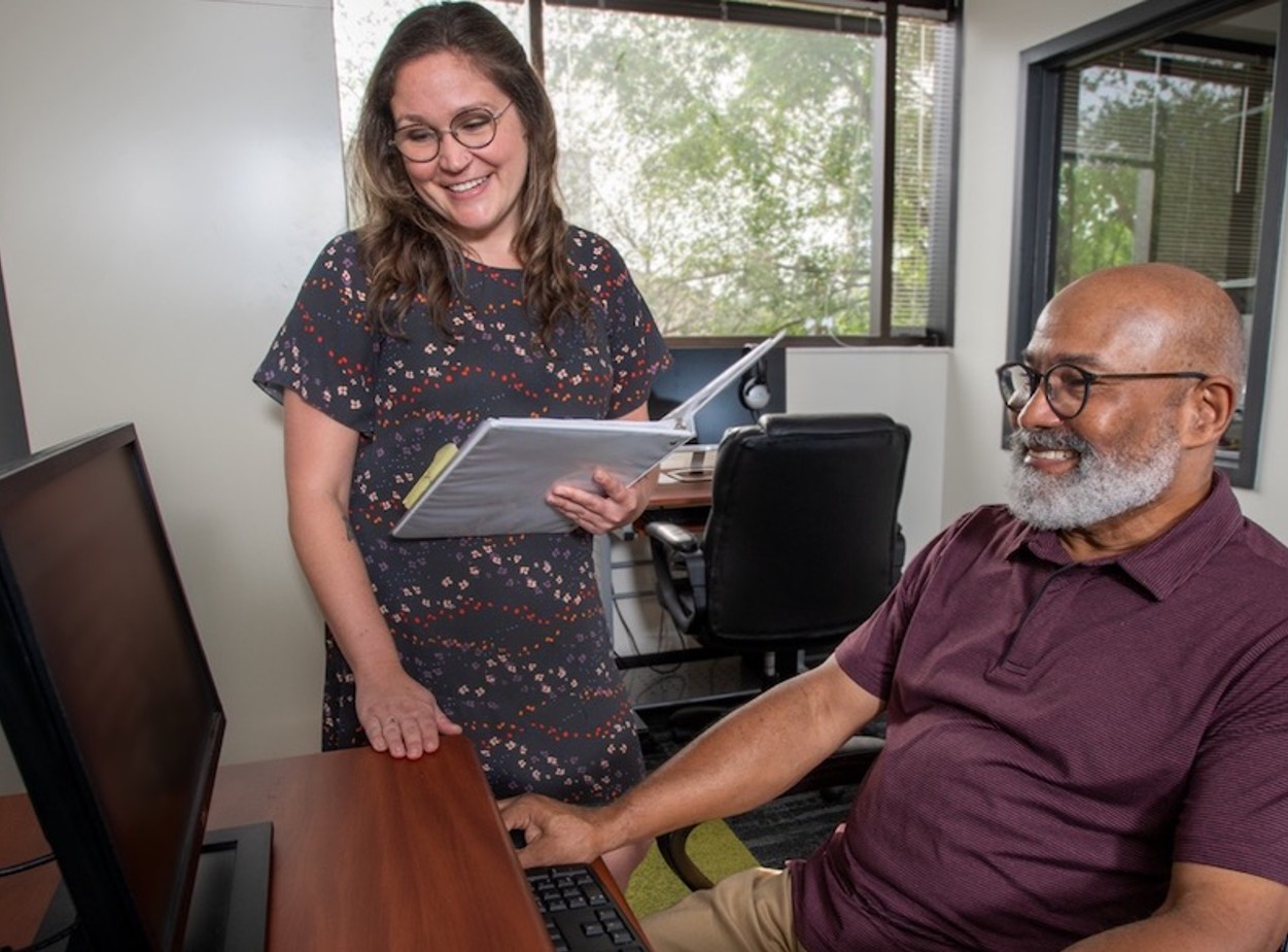 Man and woman looking at a computer together