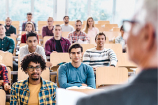 A classroom of students seen from over the shoulder of the lecturer