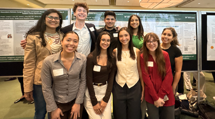 group of students in front of presentation research posters.