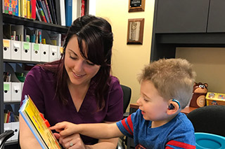 boy patient with hearing aids and SLP