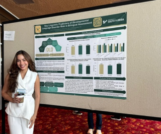 Anna in front of a presentation poster