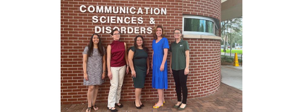 NoA Lab team members standing in front of the Communication Scienced & Disorders building