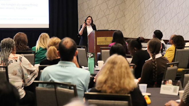 Woman speaks at podium
