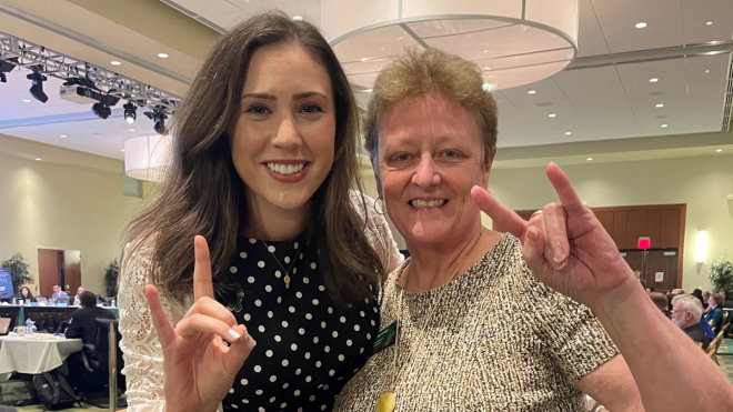 Haley Hines-Gaal stands with College of Behavioral and Community Sciences Dean Julie Serovich after the Board of Governors meeting.