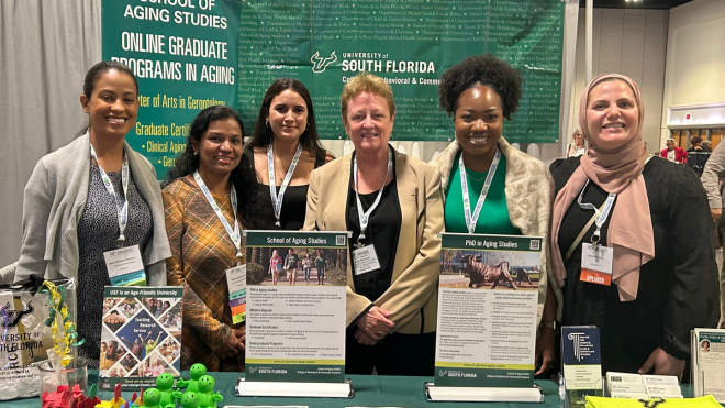 Group with CBCS Dean Julie Serovich at USF's table at the GSA meeting