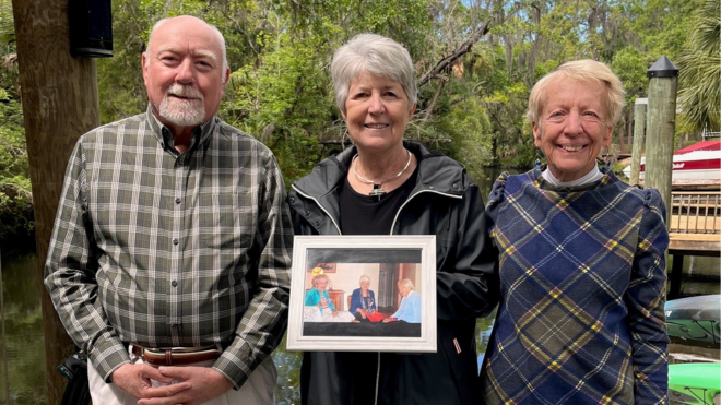 Roger Boothroyd, Catherine Batsche, and Mary Armstrong hold a photo of their mothers.