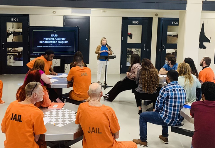 Jessica Grosholz speaks to prisoners at the Sarasota County Correctional facility