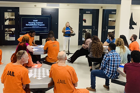 Jessica Grosholz speaks to prisoners at the Sarasota County Correctional facility