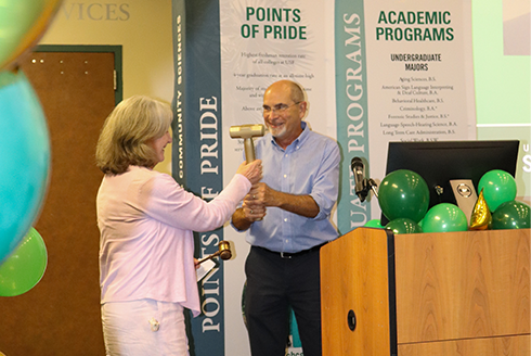 Mario Hernandez passes a gavel to Lise Fox