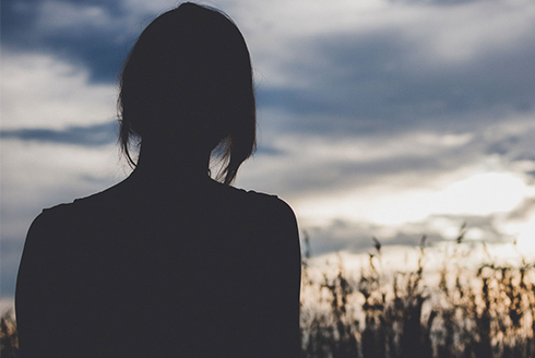 Silhouette of woman watching the sunset