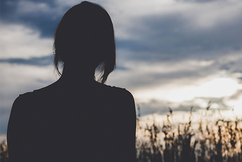 Silhouette of woman watching the sunset 