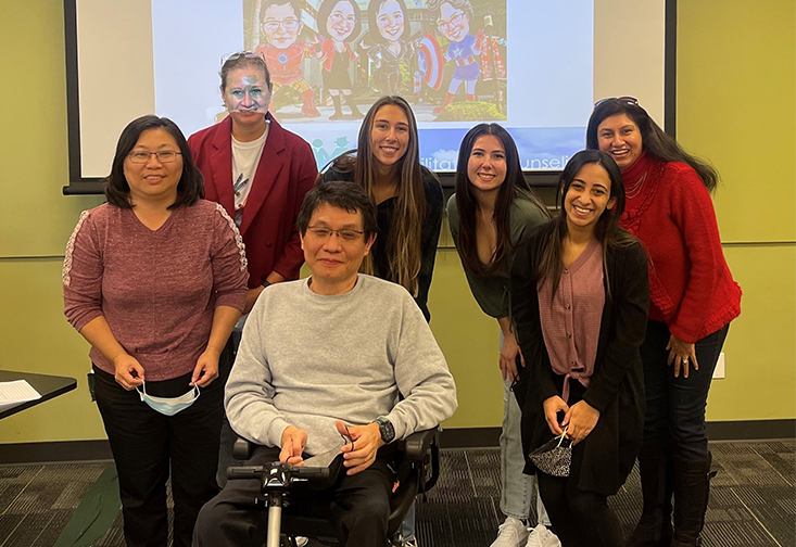 Dr. Wang poses for a photo with event attendees