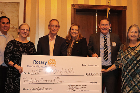 The Tampa Midtown Rotary Club presents check to University of South Florida CARD and ABA representatives