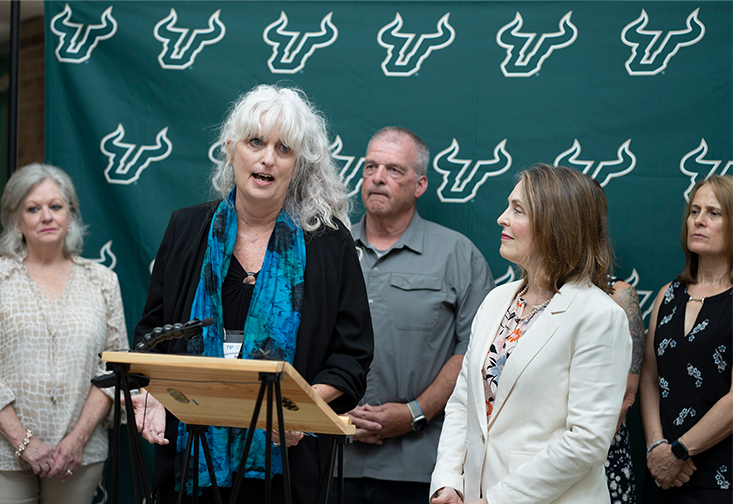 Joan Reid speaks during Rep. Castor's visit