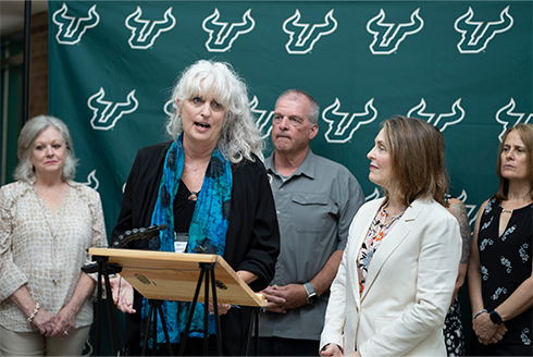 Joan Reid speaks during Rep. Castor's visit